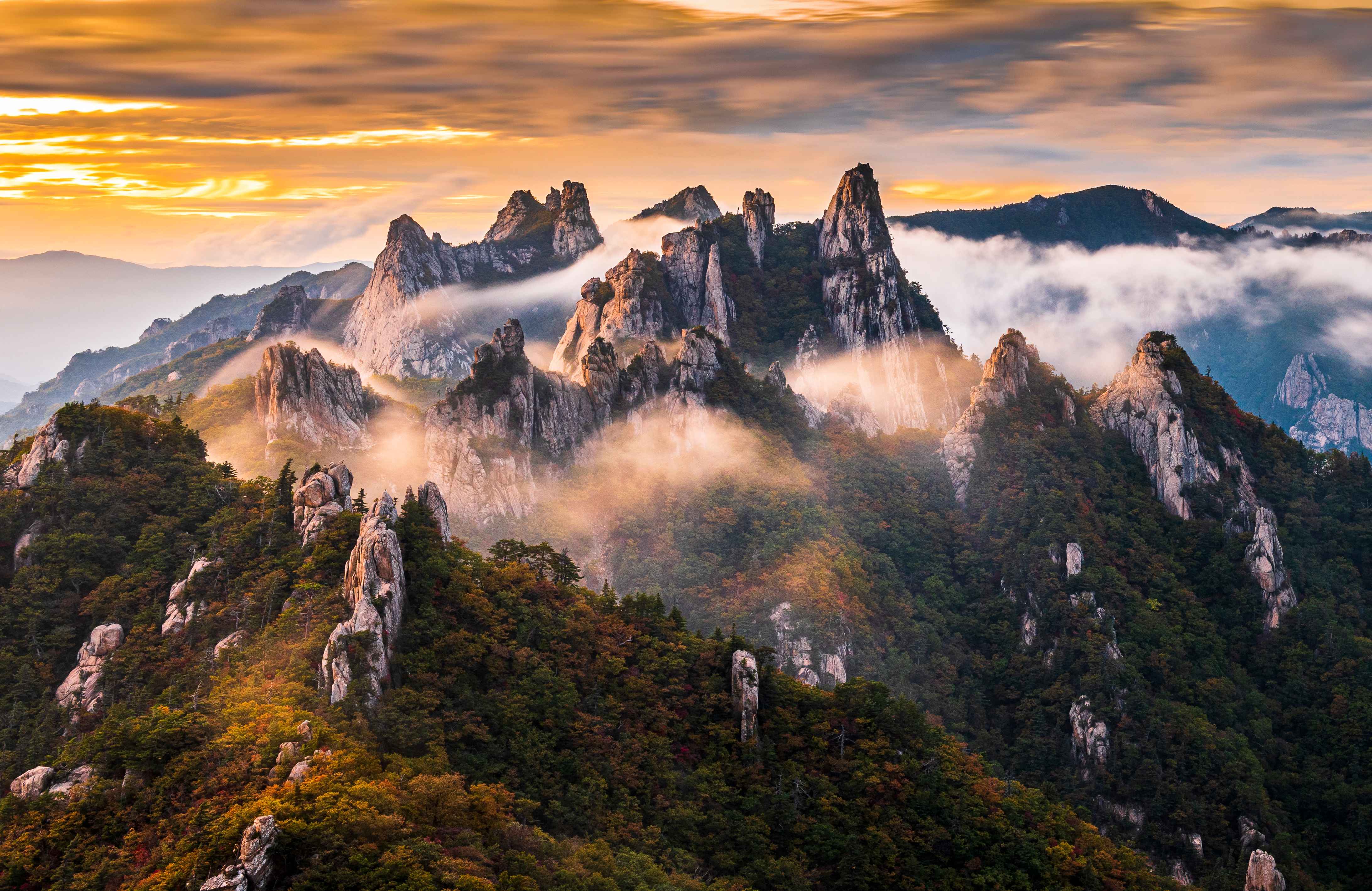 Rocky peaks of Seoraksan rising through sunrise cloud in Sokcho.